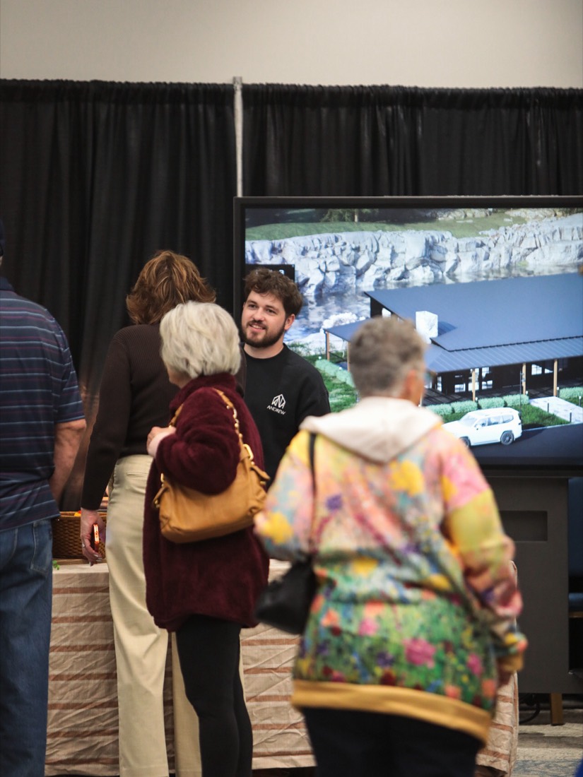 A homeowner learning from an exhibitor at a regional home show